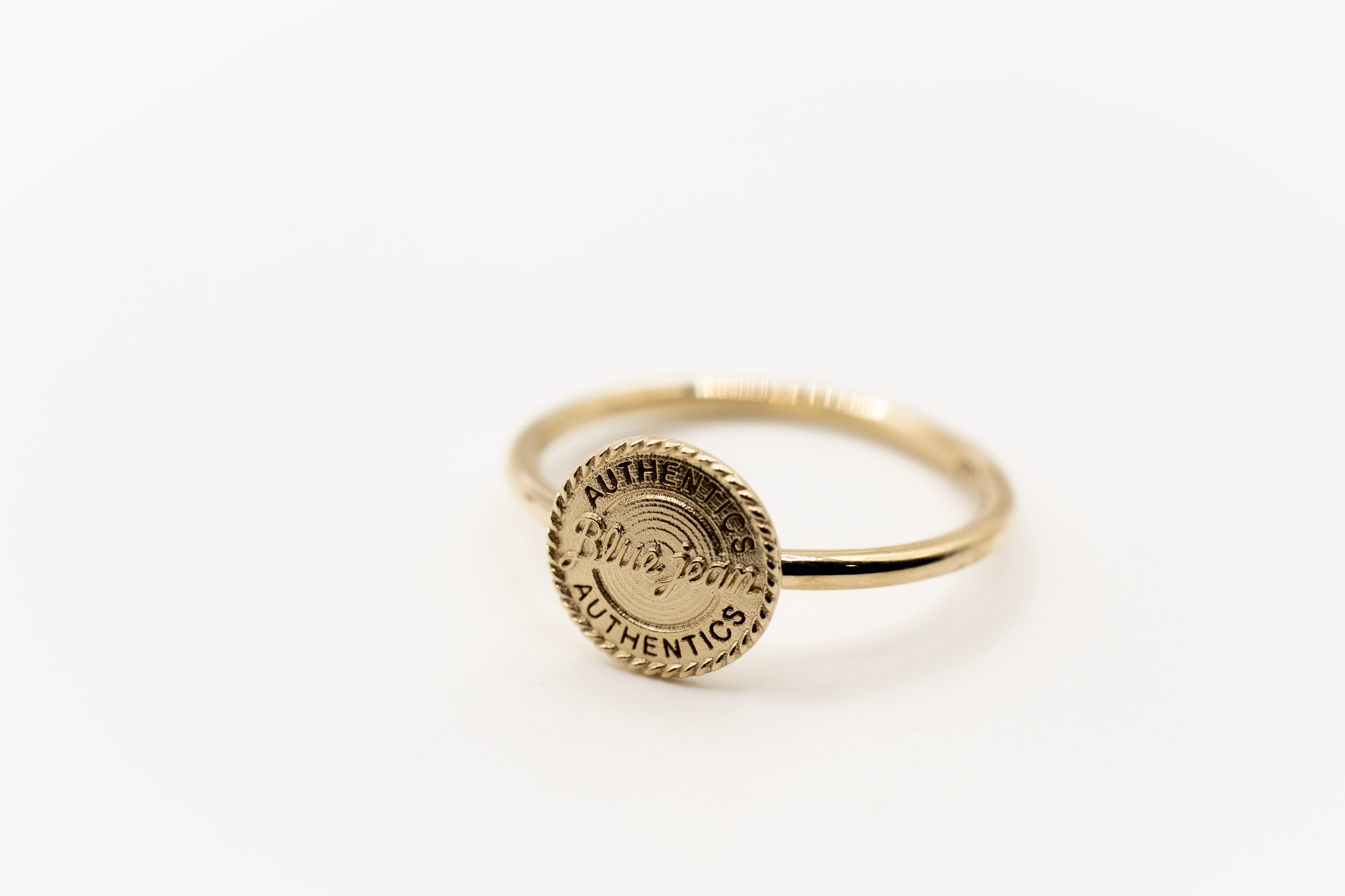 Gold ring with a western theme Wrangler on a white background