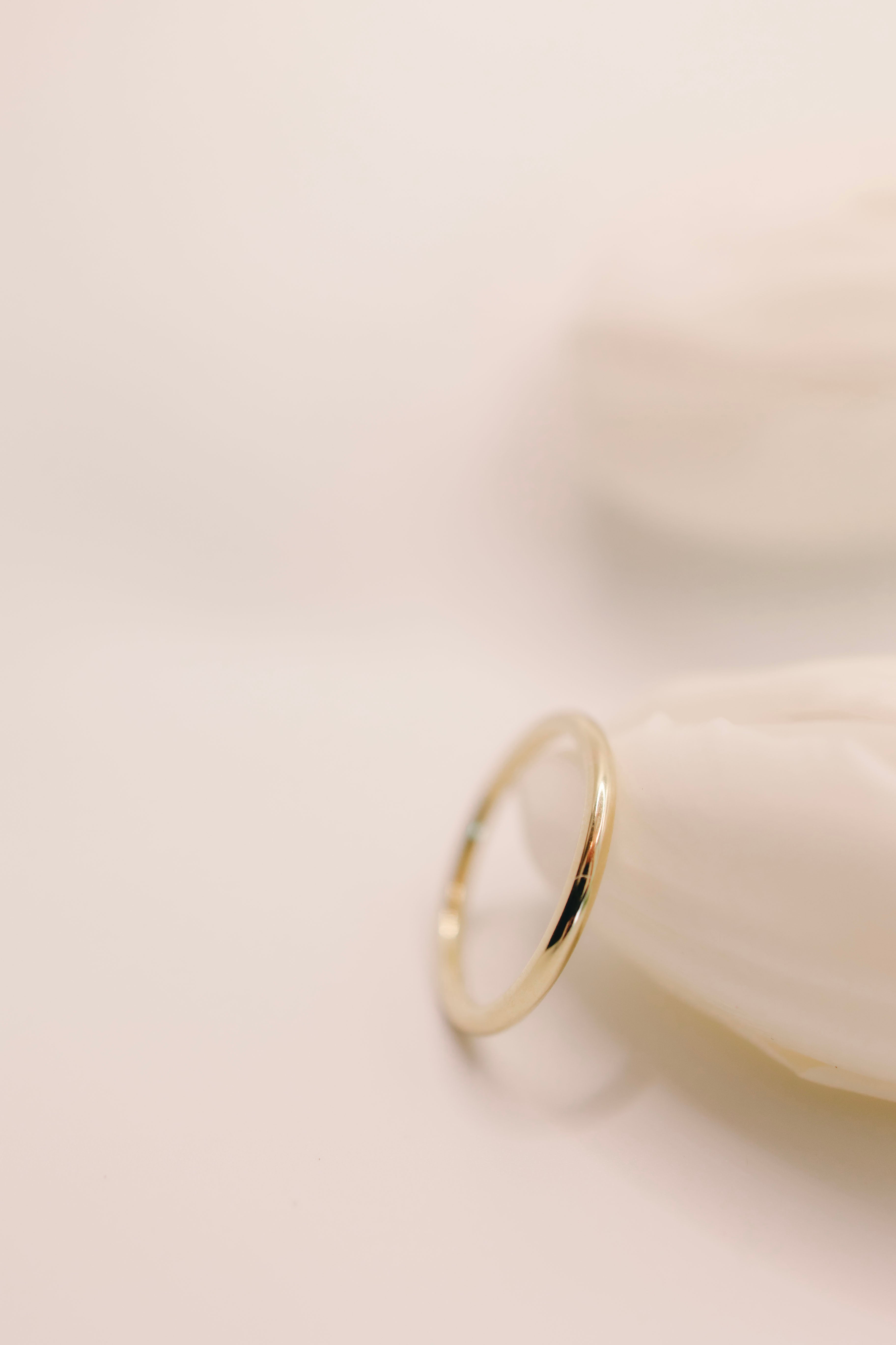 Gold ring on a light beige background