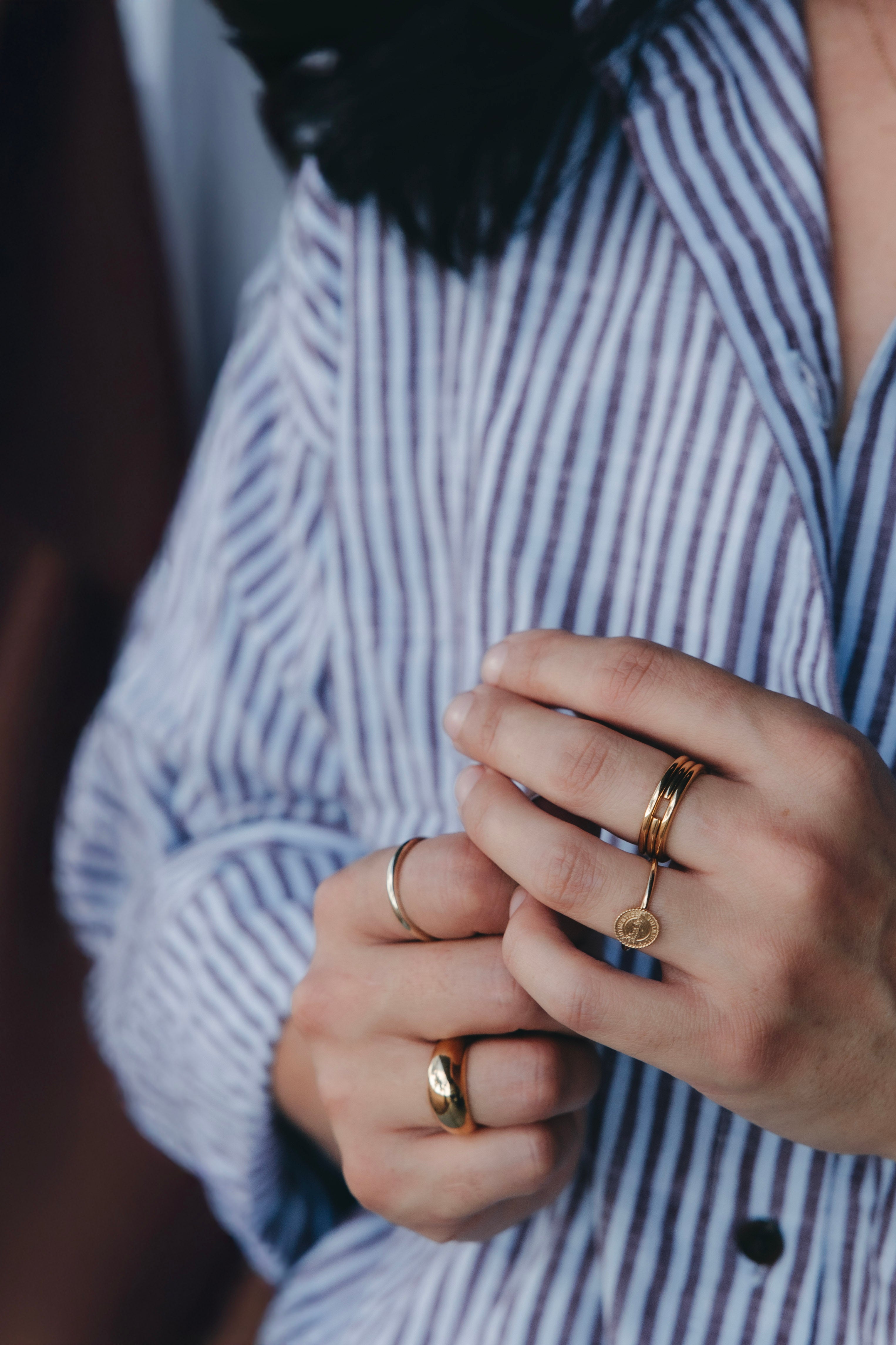 Gold rings worn by the founder of ByCC Fine Jewellery, designed for daily wear and photographed in a calm, natural setting wearing Ceres Life matching set.