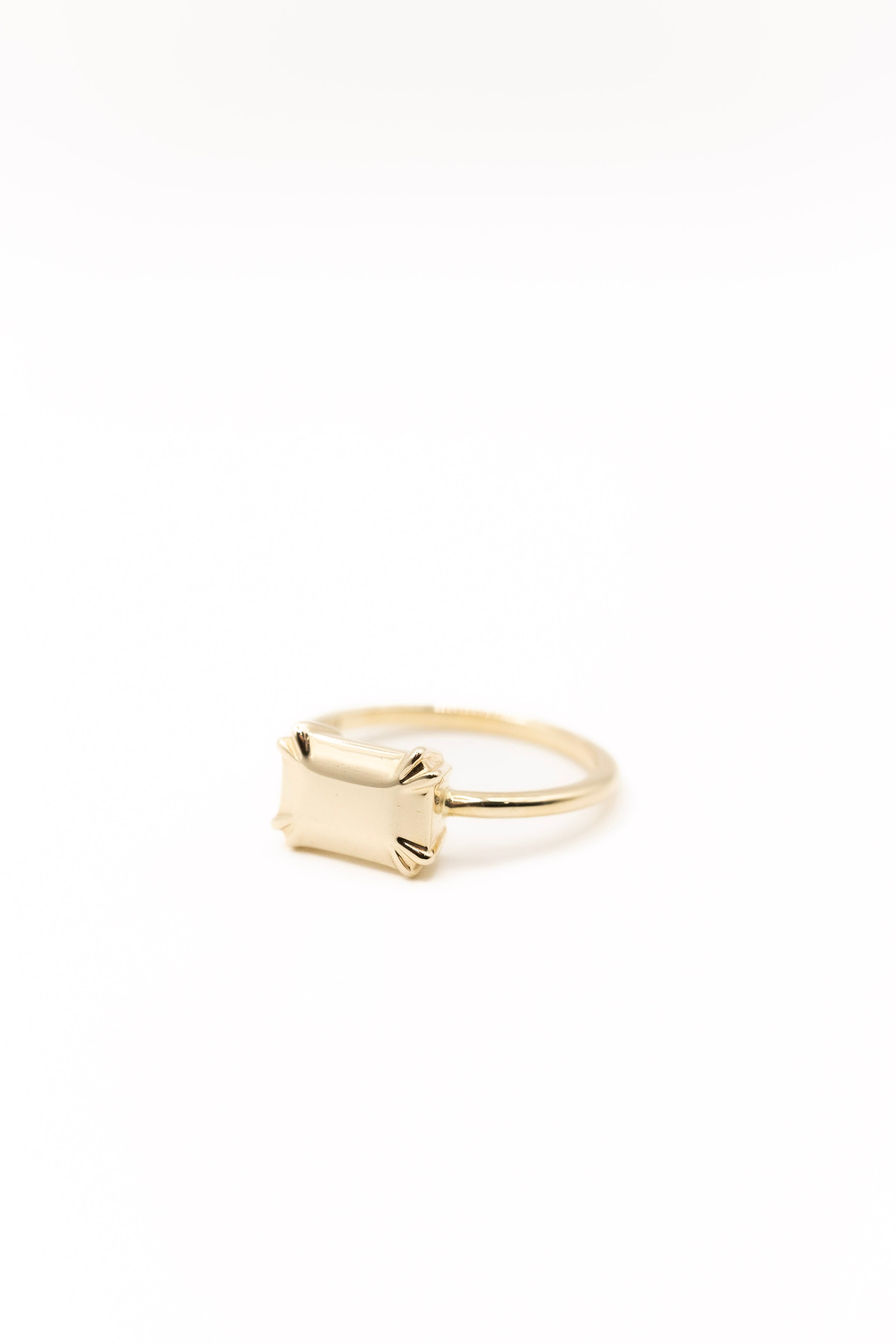Emerald Cut solid Gold ring on a white background