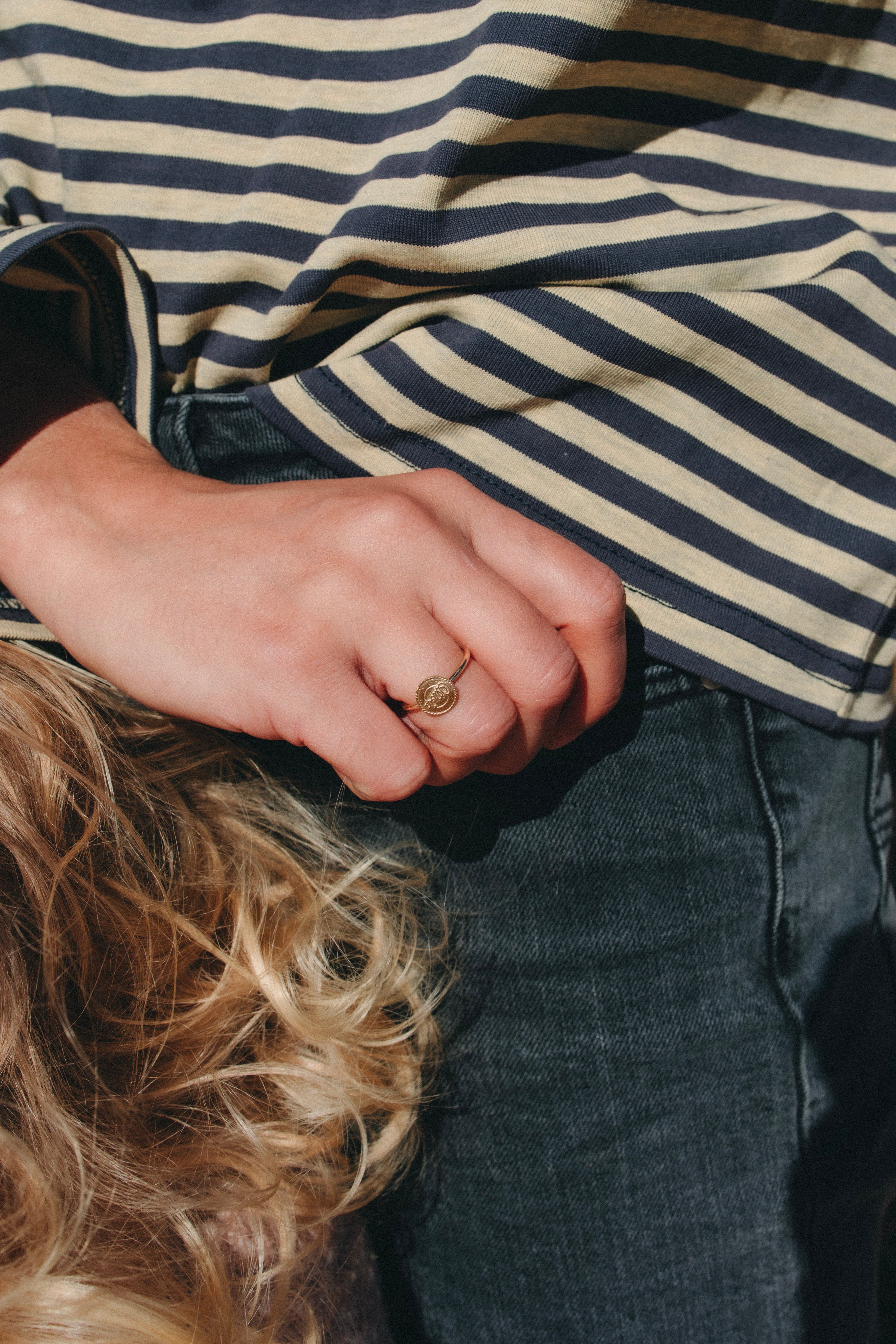 Western signet ring in solid gold worn in a natural outdoor setting in regional NSW.