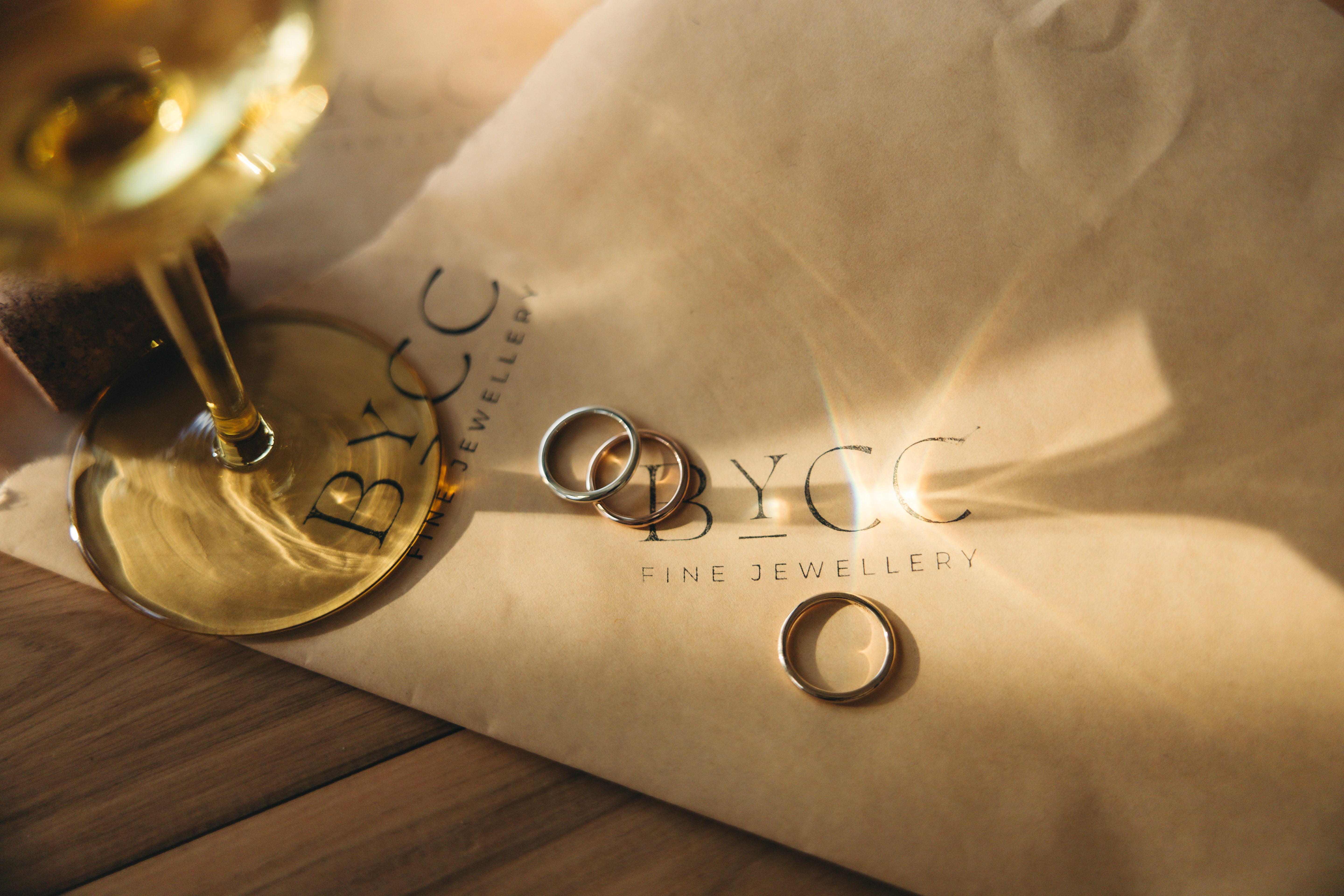 Minimal stack of solid gold rings with smooth polished finishes, worn as everyday jewellery.