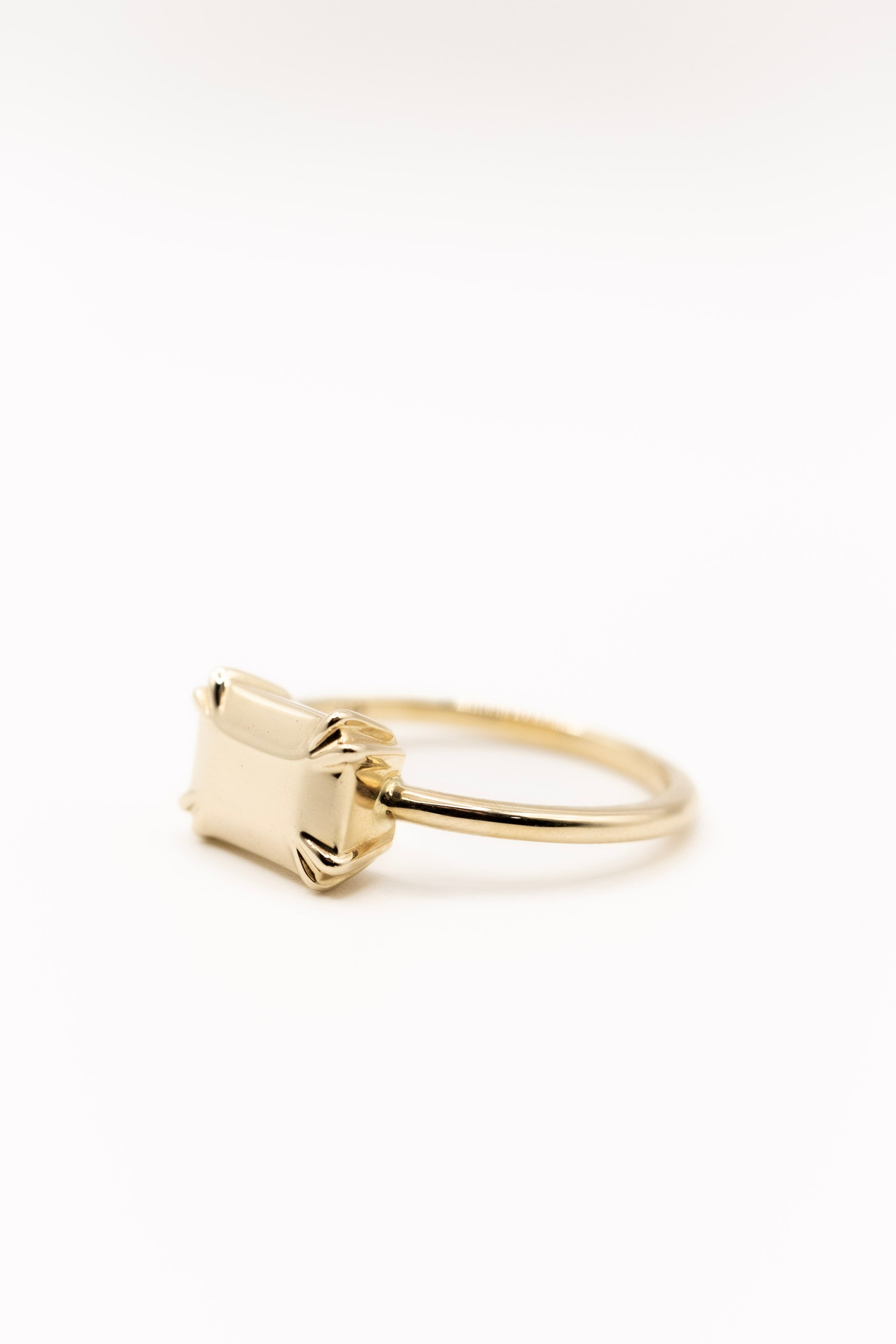 Solid gold ring with a geometric design on a white background
