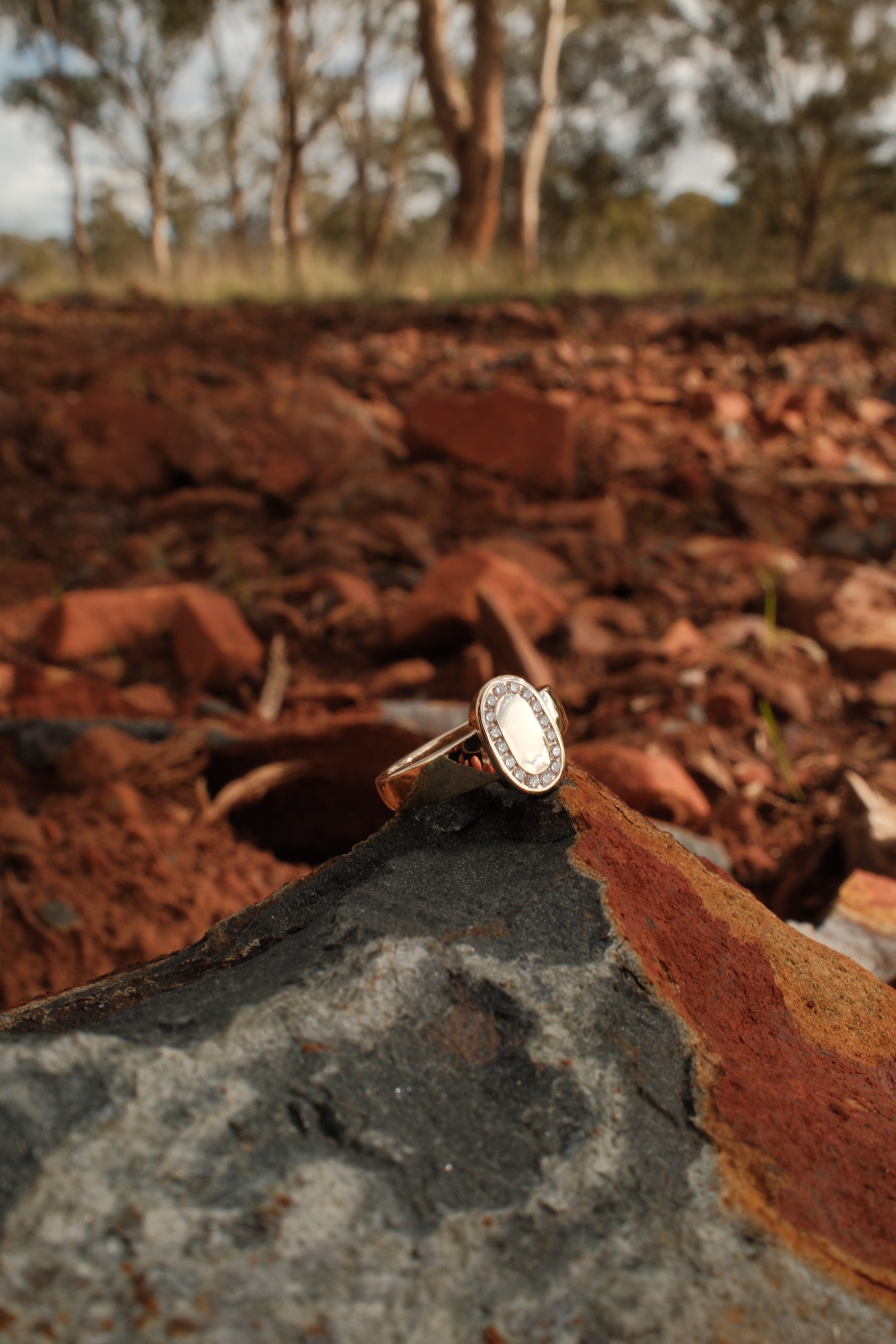 Solid Australian gold ring with diamonds shot in regional Australia Red Dirt 