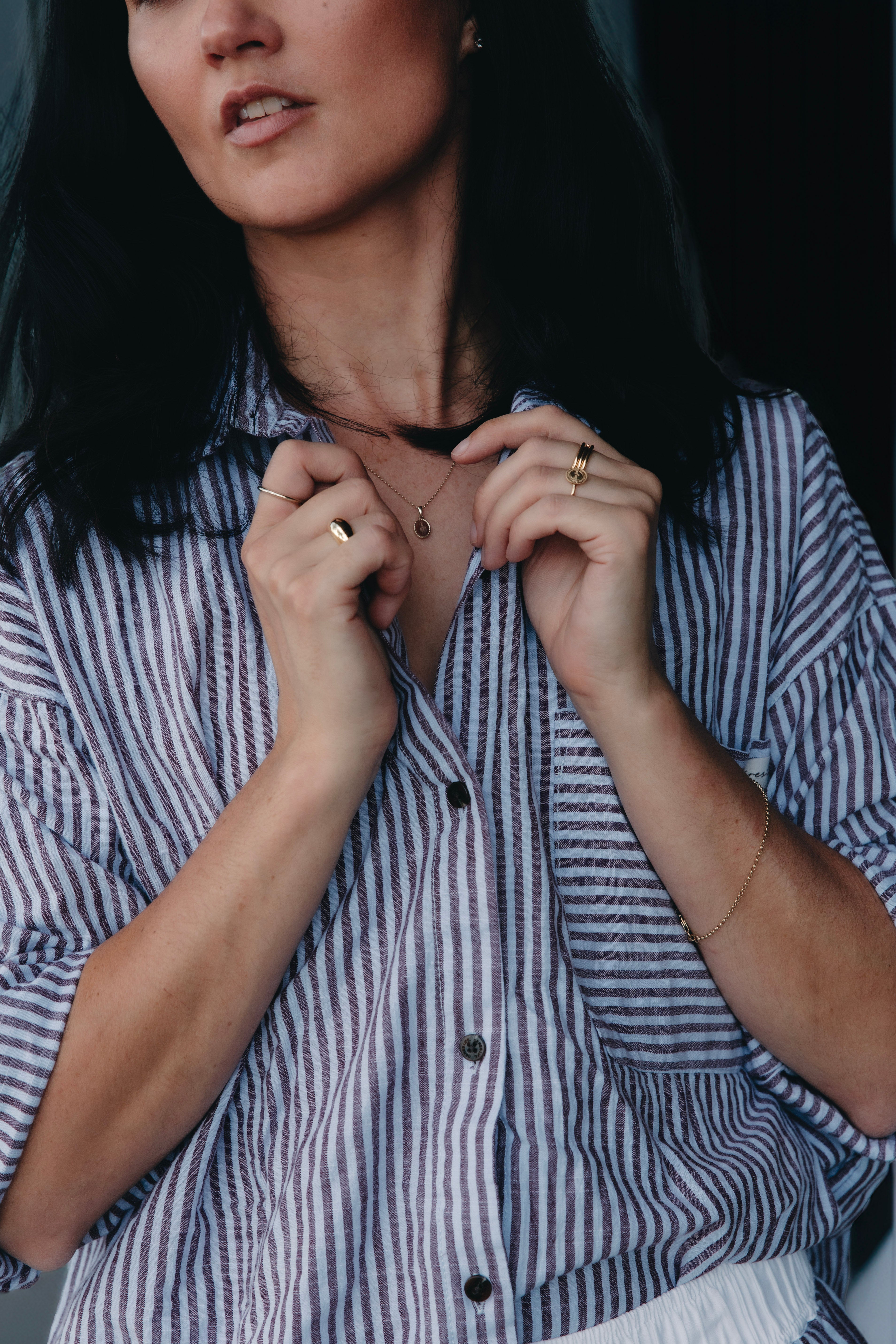 Founder of ByCC Fine Jewellery wearing a matching Ceres Life set. Wearing solid Australian gold rings and chain, photographed in soft natural light.
