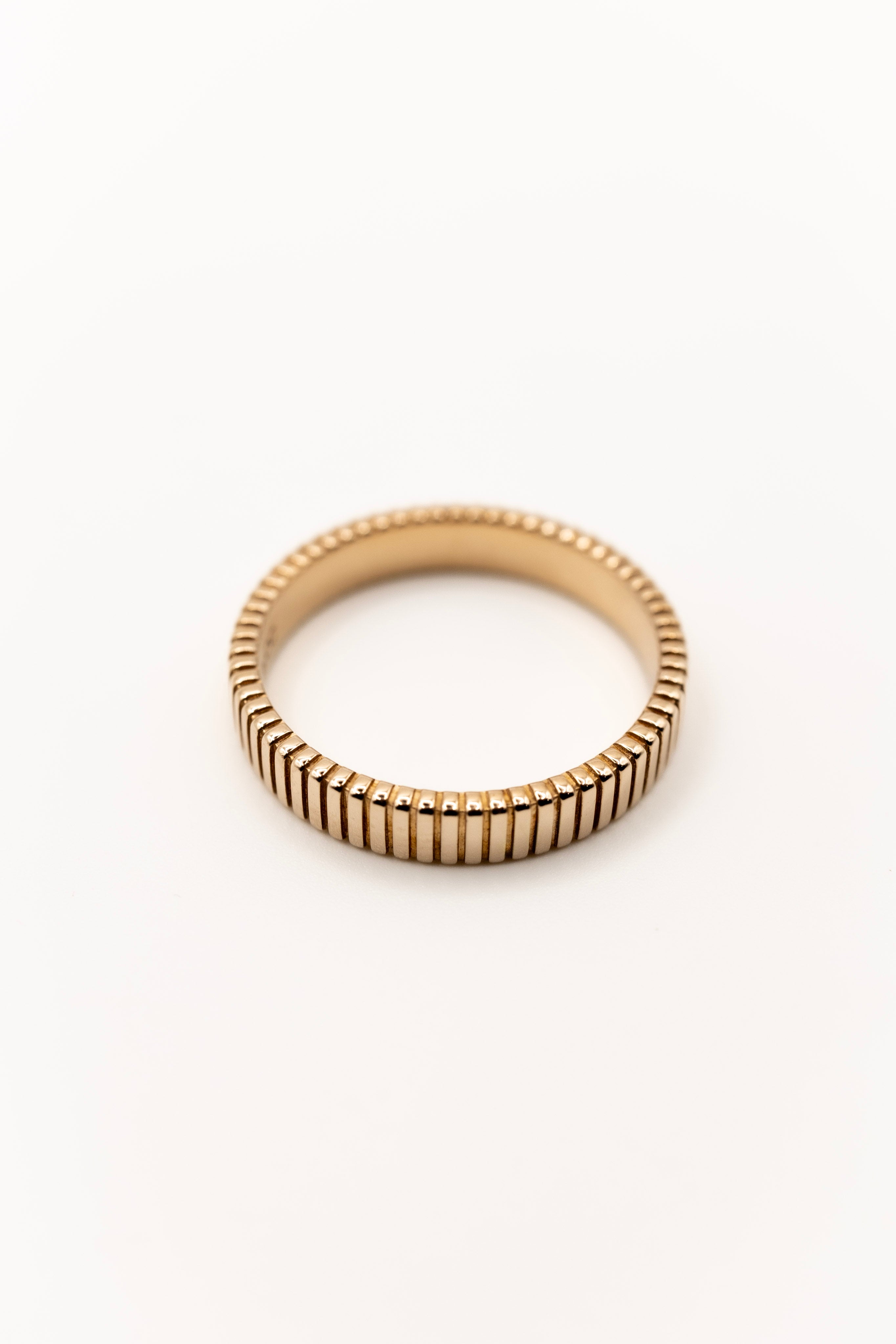 Gold ring with a textured band on a white background built for busy women 